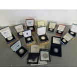 A quantity of British silver proof commemorative coinage with certificates of authenticity and cases