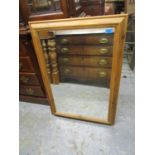 A modern pine framed wall mirror, 34 1/2" x 24 5/8", a pair of contemporary prints and another,