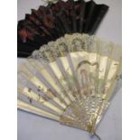 Two early 20th century fans, A/F to include a cream silk topping fan