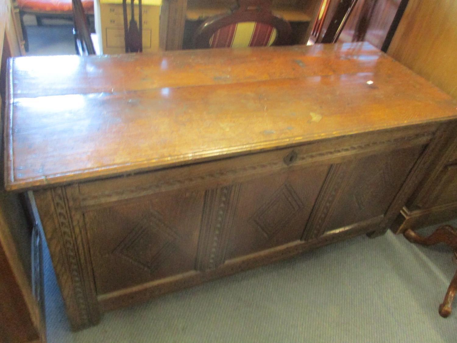 An 18th century oak panelled coffer raised on block shaped feet, 24 1/2"h x 50 3/4"w