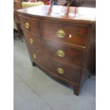 A George III bow fronted chest of two short and two long drawers on splayed legs