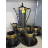 A Portmerion retro black and gold coloured coffee set designed by Susan Williams-Ellis, two cups