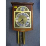 A modern mahogany cased wall hanging clock having silvered chapter ring with Roman numerals