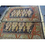 A pair of Dutch Kashmir style woollen rugs having Aztec design on a navy, red and cream background