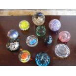 Twelve glass paperweights to include Isle of Wight glass and Bohemia examples
