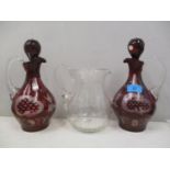 A pair of Bohemian style ruby glass wine jugs, together with a water jug