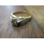 An 18ct gold ring set with an illusion set diamond