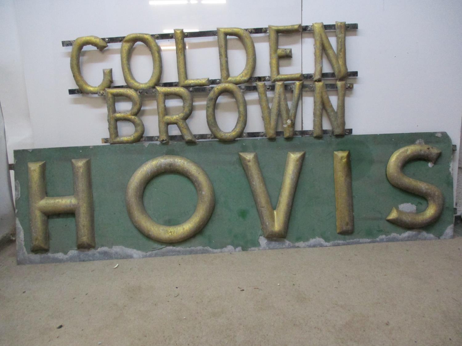 A late 19th/early 20th century gold and green painted metal Hovis Golden Brown bread sign in three