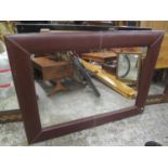 A modern brown leather framed wall hanging mirror, 33 1/4"h x 45"w