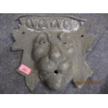 A lead outdoor fountain plaque in the form of a lion