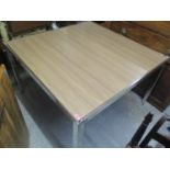 A modern contemporary square dining table having a veneered top and chrome legs, 29"h x 48"w,