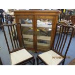 A pair of Edwardian dining chairs, together with a Victorian pine glazed bookcase