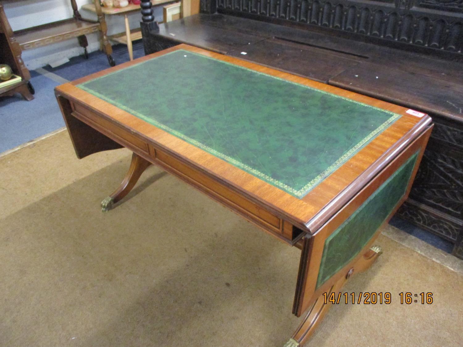 A reproduction sofa table with green scriber