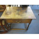 A Georgian oak side table with single frieze drawer on turned legs united by square stretchers