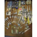 Approximately thirty four collectors spoons, together with mixed loose cutlery and flatware