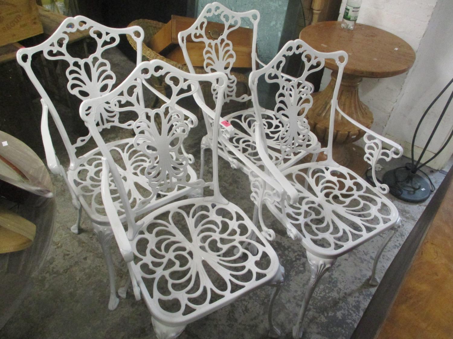 A set of four aluminium white painted garden chairs