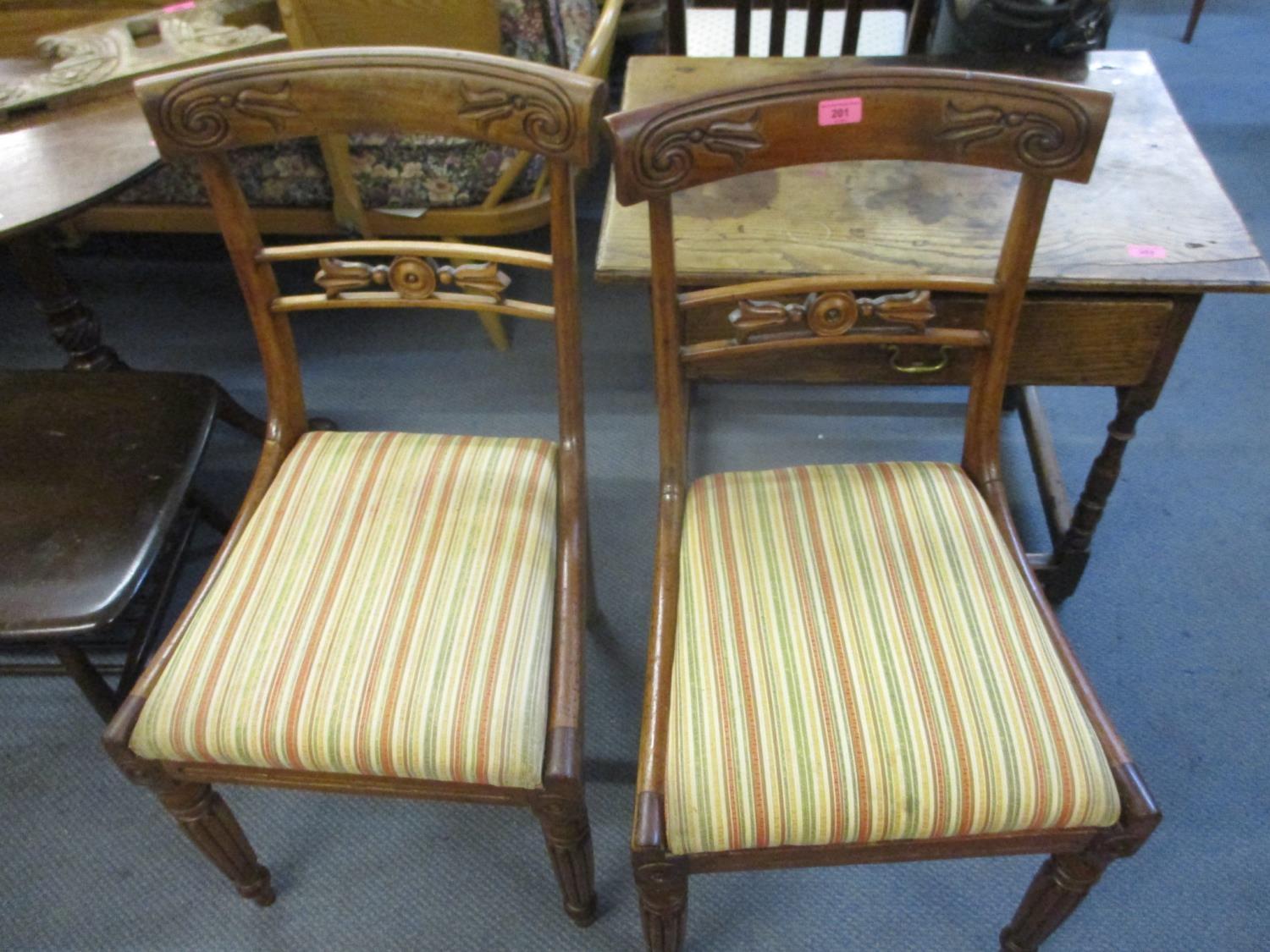 Two Victorian mahogany dining chairs with floral decorated crest rail, upholstered drop-in seats and