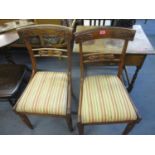 Two Victorian mahogany dining chairs with floral decorated crest rail, upholstered drop-in seats and