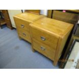 A pair of modern oak twin door bedside chests