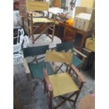 A folding teak circular topped garden table and a set of four folding chairs