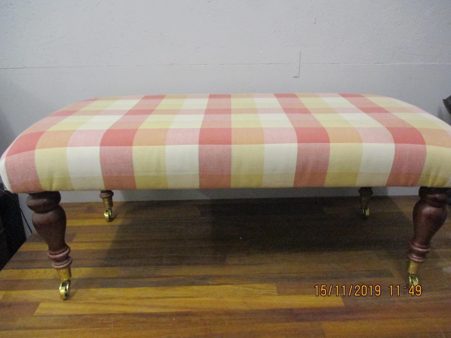 A modern mahogany double foot stool with chequered upholstery