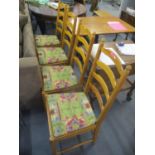 A set of four Ercol pine ladder back dining chairs