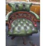 A reproduction green leather button back Captains armchair