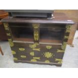 An Oriental brass bound low cabinet having glazed doors above two drawers and cupboard doors 27 1/2"