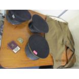 Military related items to include three caps with badges, jodhpurs, a belt buckle and other badges
