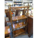 A reproduction mahogany four tier open bookcase having acorn finials and two short drawers below,