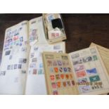 A small quantity of stamps in three small student albums and a quantity of loose stamps