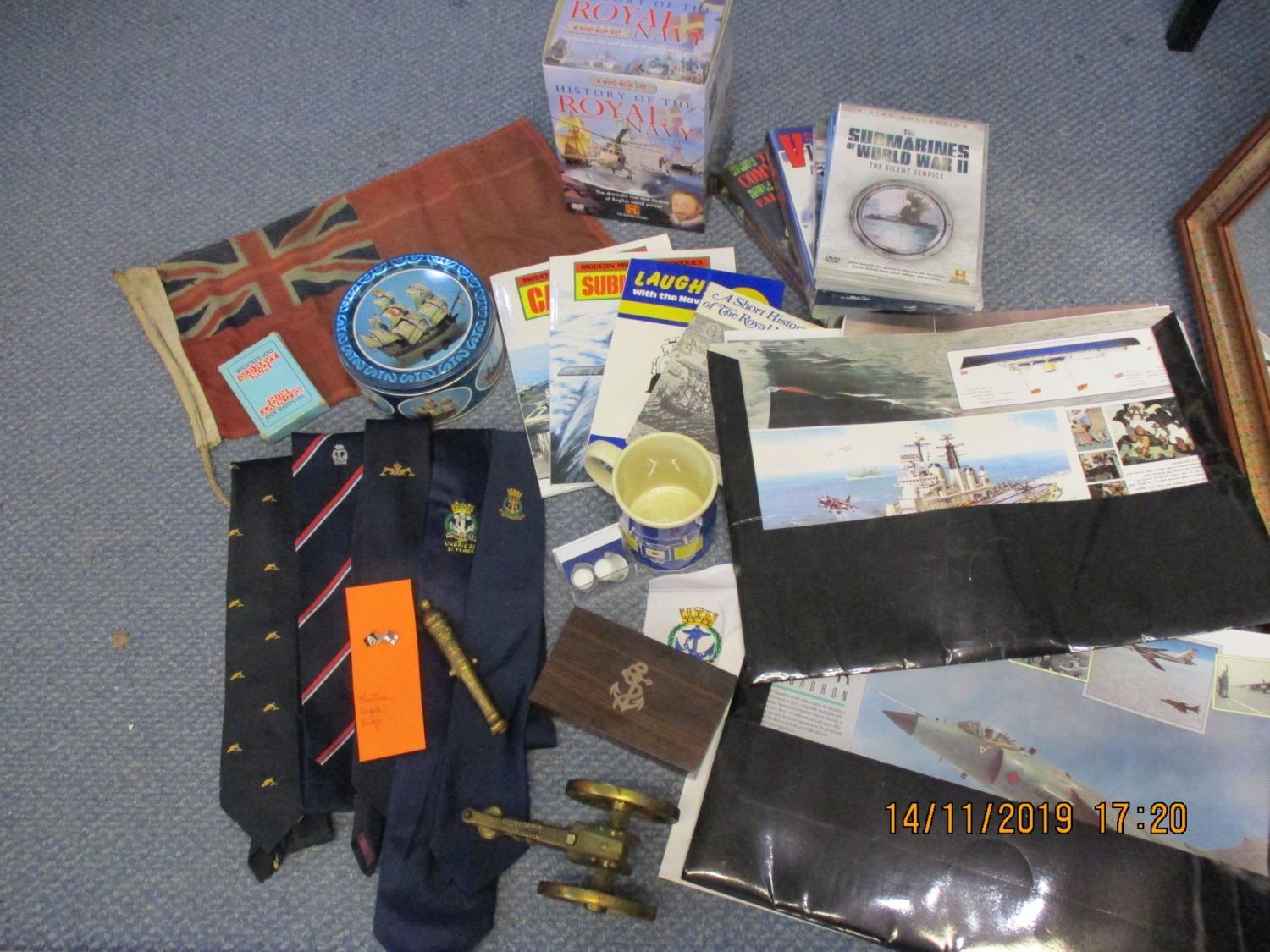 Navy related items to include ephemera, DVDs, books, ties, a tin, a flag and a canon