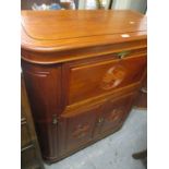 An Oriental rosewood drinks cabinet having a fall flap above two panelled doors 42"h x 35 3/4"w