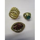 A yellow metal and silver brooch set with rubies A/F, a gold coloured metal ring set with a