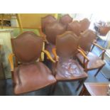 A set of eight walnut shield back corner dining chairs having button leather back upholstery