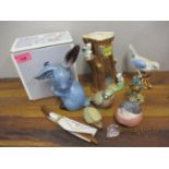 A Sylvac blue pottery bunny, a Russian model of a bird, a glass Goebel model of a hedgehog, and