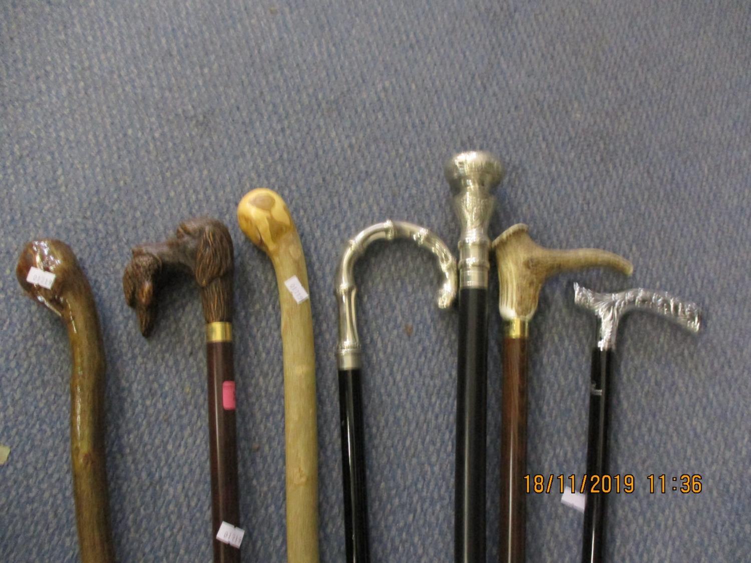 Seven walking canes, all reproductions to include a silver plated handle example and one with a