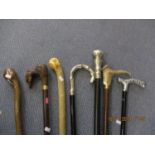 Seven walking canes, all reproductions to include a silver plated handle example and one with a
