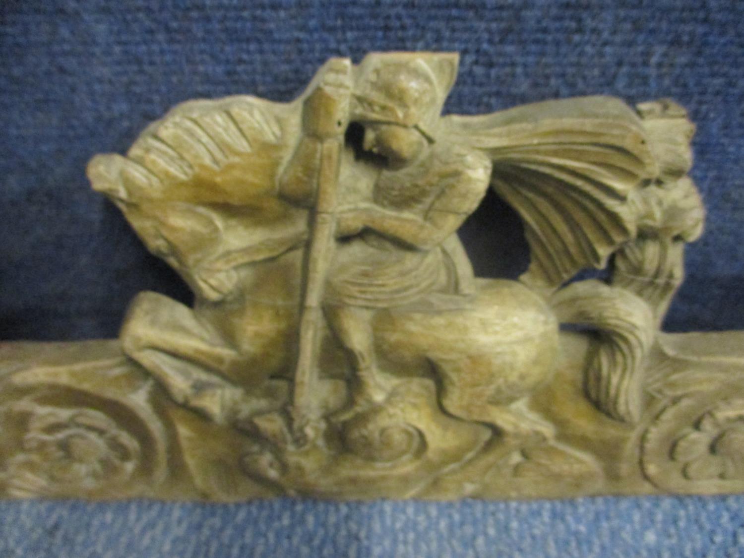 A walnut carved panel depicting St George and the Dragon flanked by seated figures above flower - Image 2 of 3