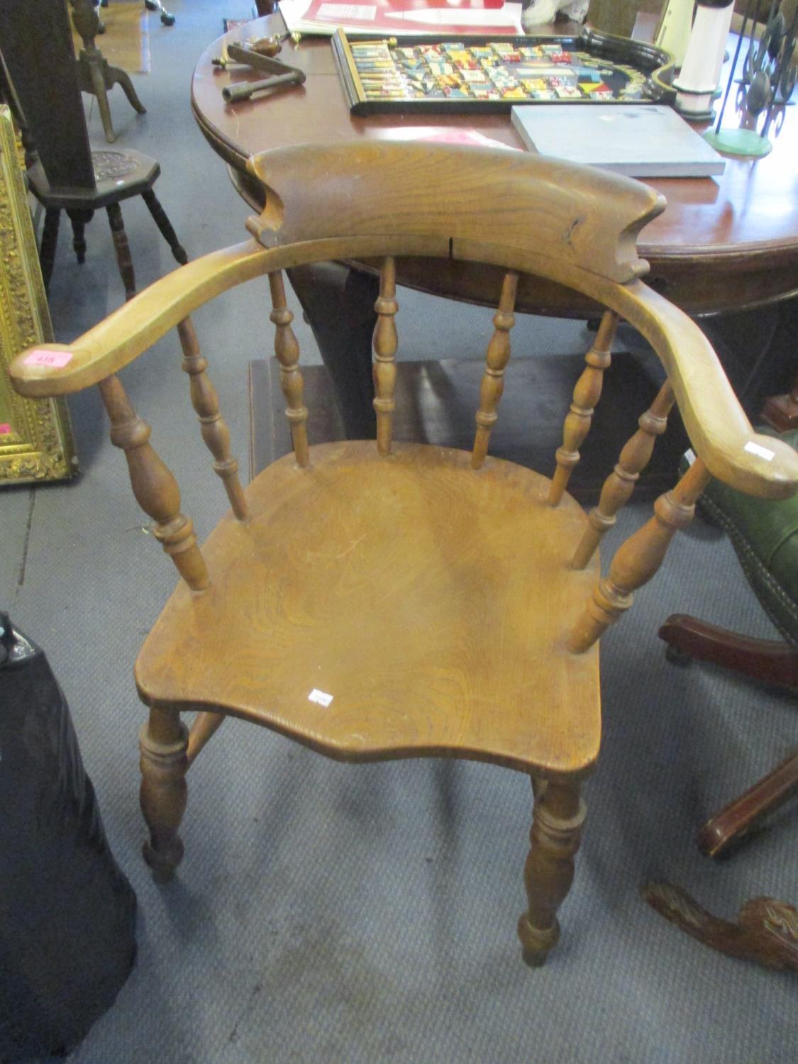 An early 20th century elm spindle back Captains chair