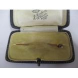 A boxed 15ct rose gold pearl and pink stone set stick pin, 1.05g