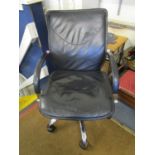 A faux black leather and chrome swivel office chair with arms and castors