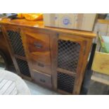 A modern teak cabinet having three central drawers flanked by two cupboard doors 41"h x 45"w