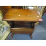 An early 20th century armchair, together with a magazine rack/table