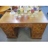 An Edwardian inlaid mahogany twin pedestal writing desk with extended back, central frieze drawer