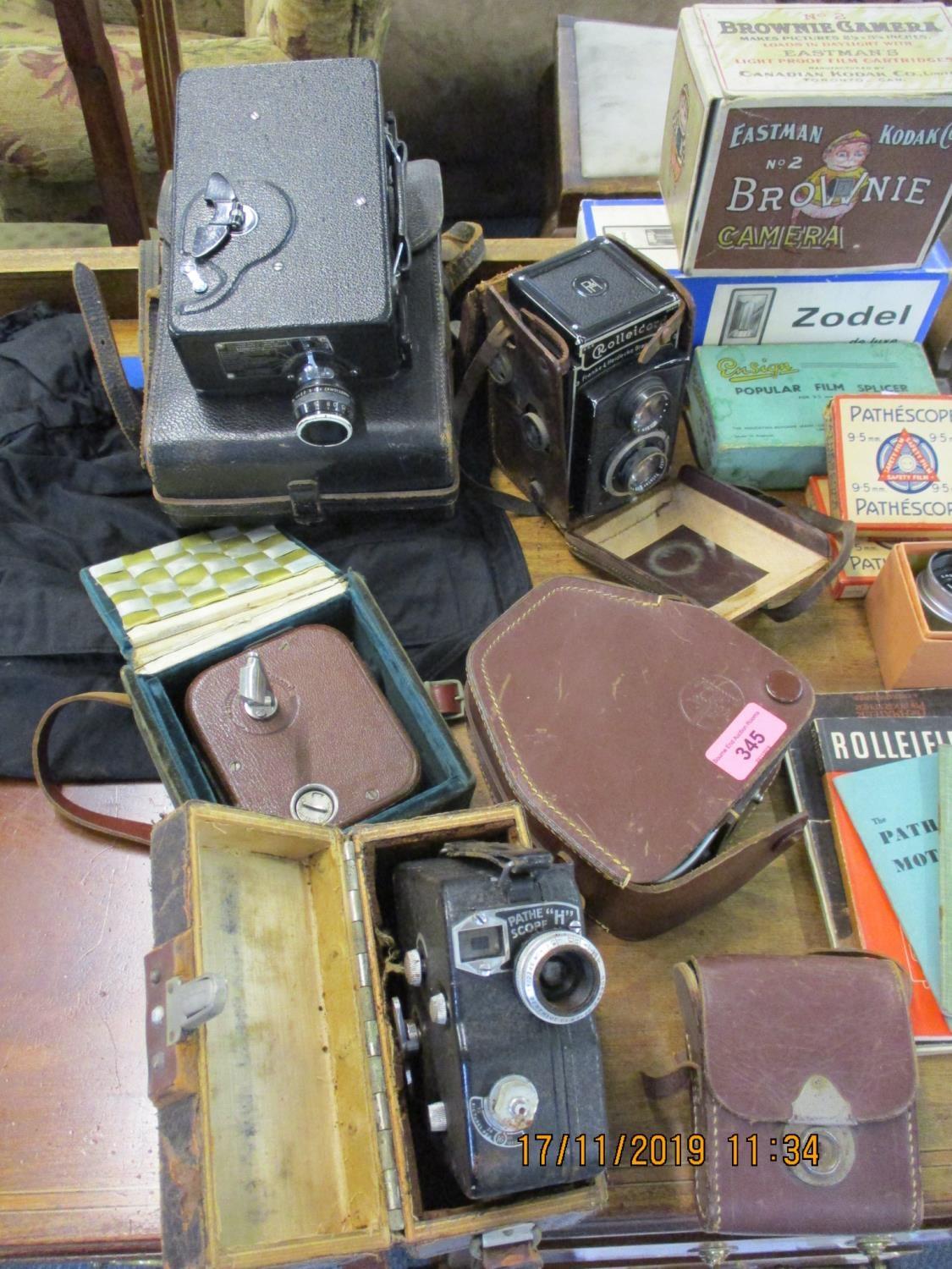 Vintage cameras and accessories to include Rolleicord, a cine Kodak, a box Brownie in original box