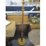 A gilt painted standard lamp having a fluted column and leaf shaped base