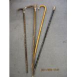 Mixed walking sticks to include two with silver rims, one with an 18ct top and one with a whistle