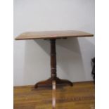 An early 19th century mahogany rectangular snap top table on tripod base