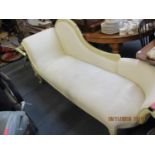 A modern Victorian design chaise longue with an off white painted, carved frame and calico